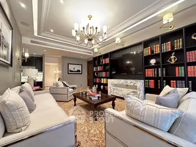 Luxurious living room with elegant chandelier and built-in bookshelves, perfect for sophisticated gatherings.