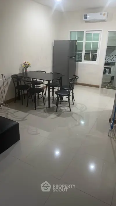 Modern dining area with sleek black furniture and air conditioning