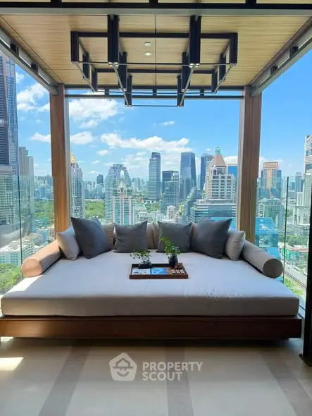 Luxurious balcony with stunning city skyline view and cozy seating area.