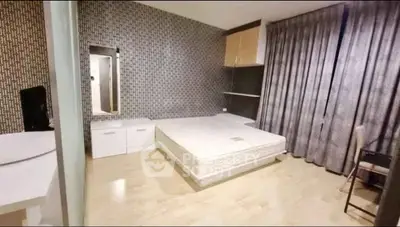 Spacious modern bedroom with stylish decor and ample natural light