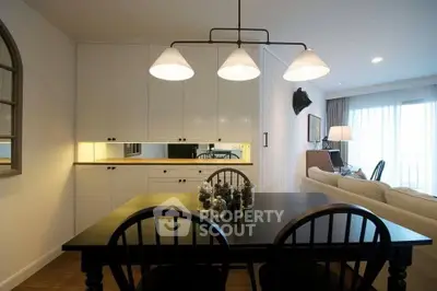 Charming dining area with elegant lighting and cozy living room ambiance.