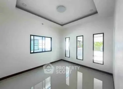 Spacious empty room with large windows and glossy floor, perfect for customization.