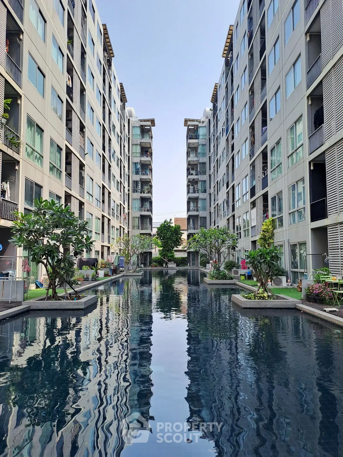 Luxurious apartment complex with stunning central pool and modern architecture