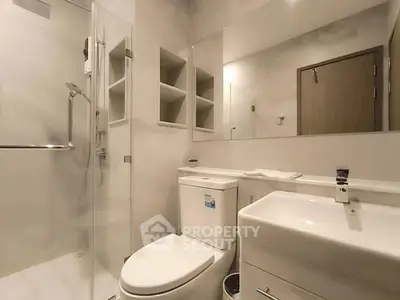 Modern bathroom with sleek fixtures and glass shower enclosure