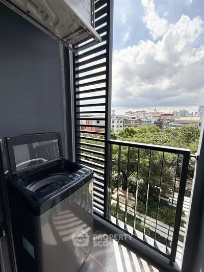 Modern balcony with washing machine and city view, perfect for urban living.