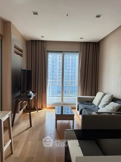 Modern living room with large window and stylish furniture in urban apartment.