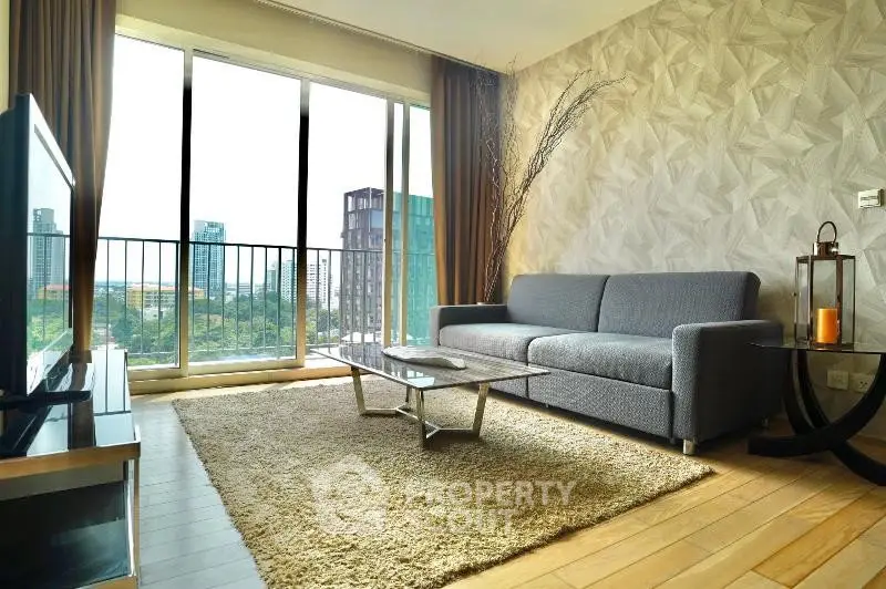 Modern living room with large windows and city view, featuring stylish furniture and elegant decor.