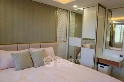 Luxurious bedroom with elegant decor and plush bedding in modern apartment.