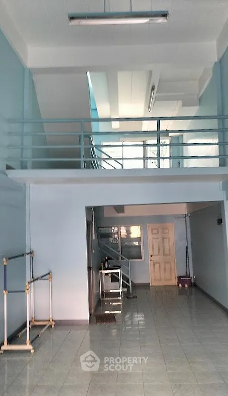 Spacious two-story interior with high ceilings and modern design, perfect for versatile living or commercial use.