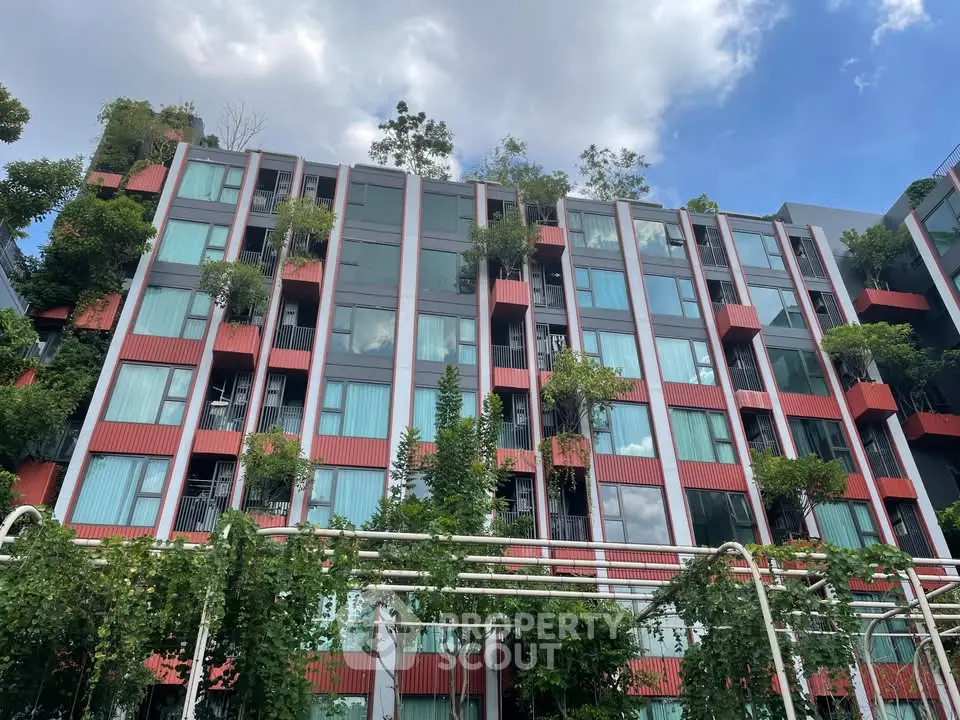 Modern eco-friendly building with lush greenery and large windows