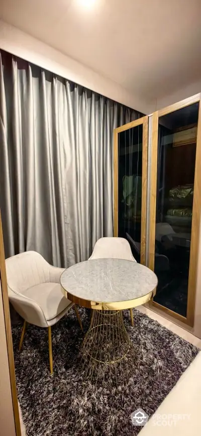 Cozy modern nook with elegant chairs and marble table in stylish apartment.