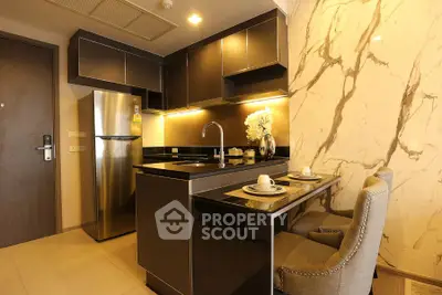 Modern kitchen with sleek black cabinets and marble accent wall