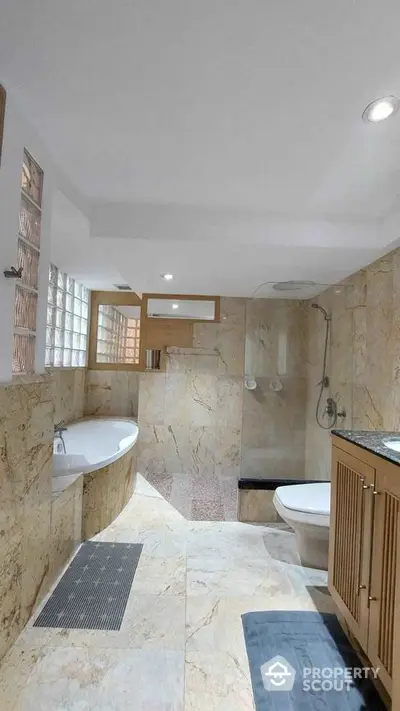 Luxurious marble bathroom with bathtub and modern fixtures