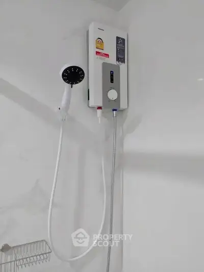 Modern bathroom with sleek shower unit and white tiled walls