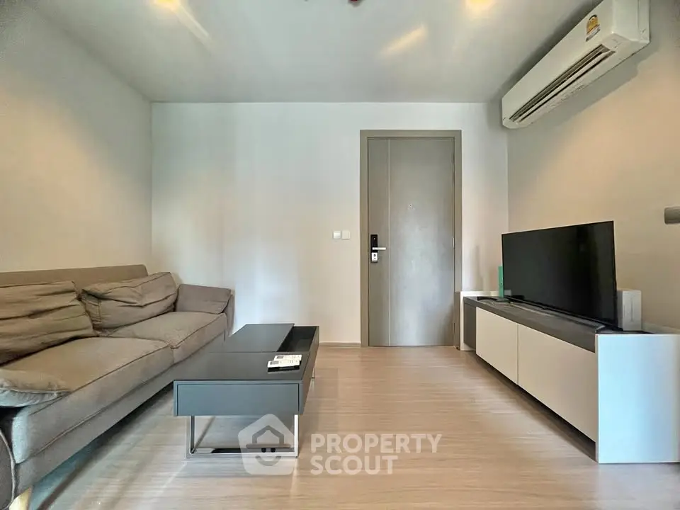 Modern living room with sleek furniture and air conditioning, perfect for comfortable living.