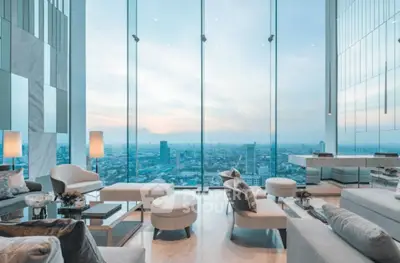 Luxurious high-rise living room with panoramic city views and elegant modern decor.