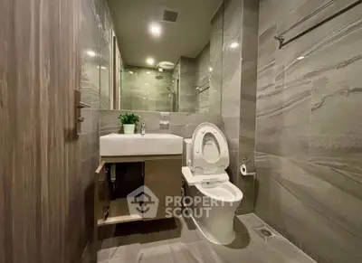Modern bathroom with sleek gray tiles and contemporary fixtures
