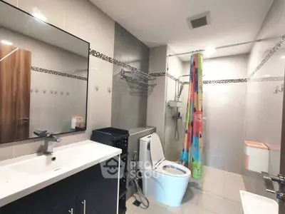 Modern bathroom with sleek fixtures and colorful shower curtain