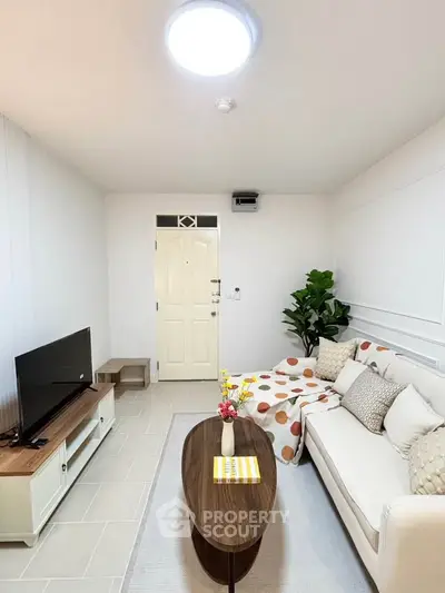 Charming living room with cozy sofa, modern TV stand, and stylish decor