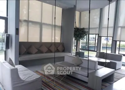 Modern living room with stylish furniture and large windows offering natural light.