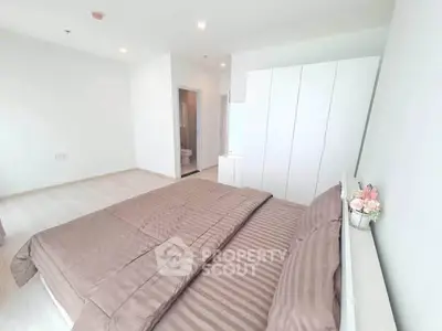 Spacious modern bedroom with elegant decor and ample natural light