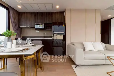Modern open-layout kitchen and living room with stylish decor and natural light.
