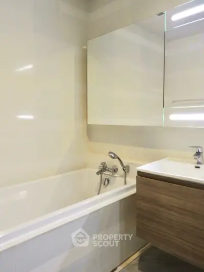 Modern bathroom with sleek fixtures and a stylish vanity unit.