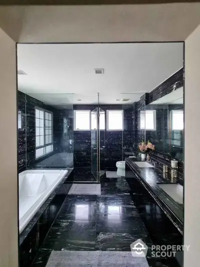 Luxurious black marble bathroom with bathtub and elegant fixtures