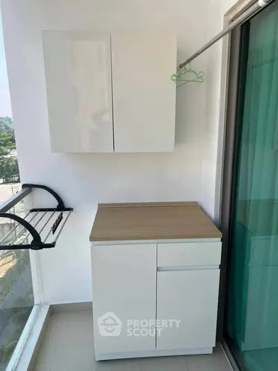 Chic balcony with modern storage cabinets and a serene view, perfect for urban living.