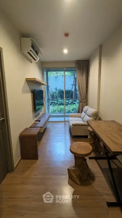 Modern living room with garden view, featuring stylish furniture and natural light.