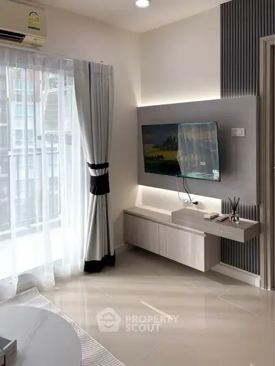 Modern living room with sleek TV setup and large window view