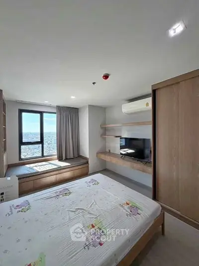 Modern bedroom with city view, featuring built-in storage and air conditioning.