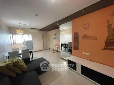 Spacious living room with modern decor and dining area, featuring unique wall art and ample natural light.