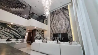 Luxurious modern living room with high ceilings and elegant marble accents