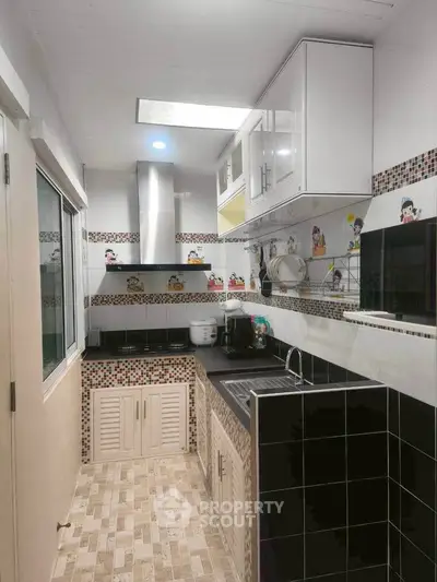 Charming kitchen with modern appliances and stylish backsplash in cozy layout.