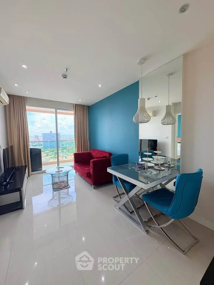 Modern living room with vibrant decor and city view, featuring stylish furniture and natural light.