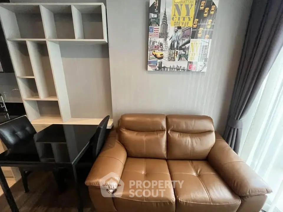 Modern living room with leather sofa and stylish wall art in a cozy apartment.