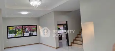 Spacious modern living room with elegant chandelier and staircase