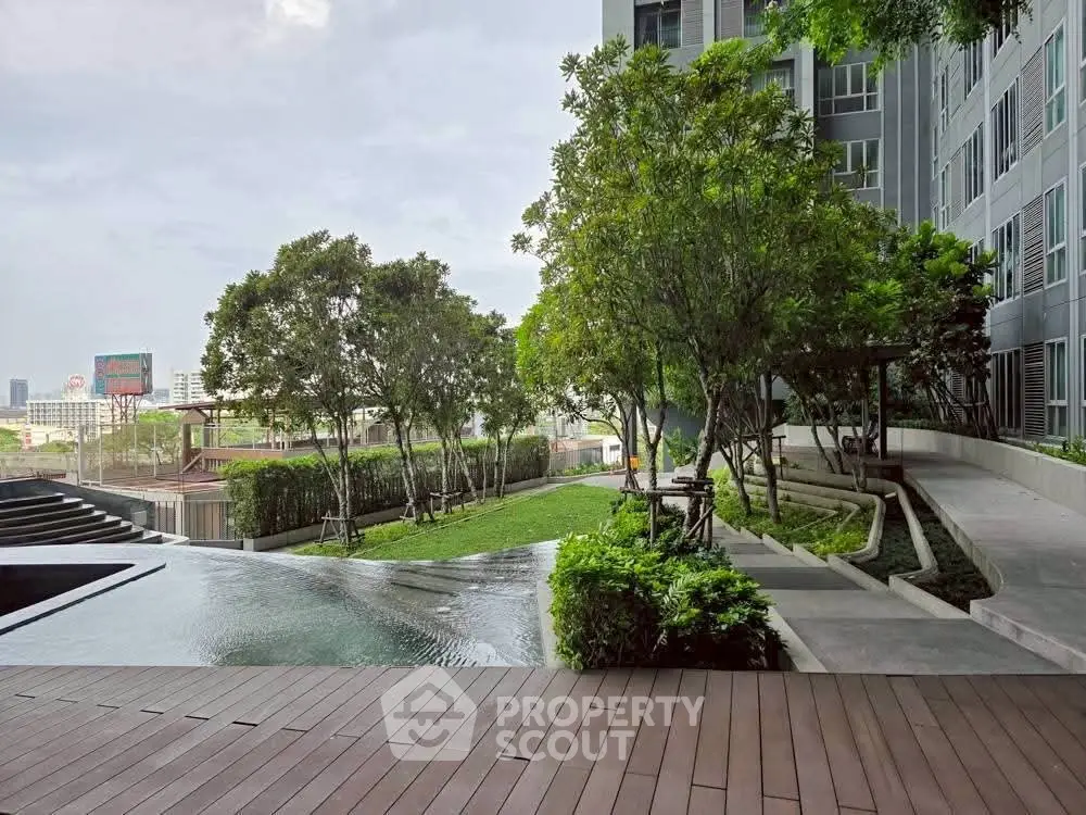 Luxurious condominium with serene garden and pool view, perfect for relaxation and urban living.