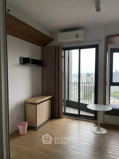 Modern apartment interior with balcony view, featuring sleek design and natural light.