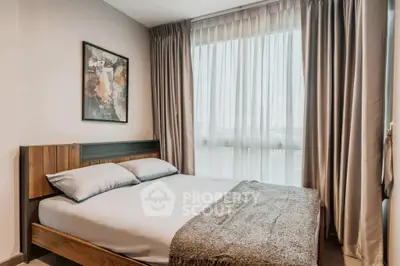 Modern bedroom with cozy bed and large window for natural light
