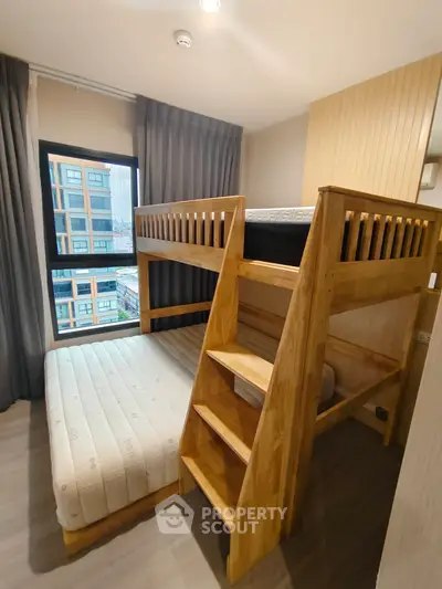 Modern bedroom with stylish wooden bunk bed and city view window