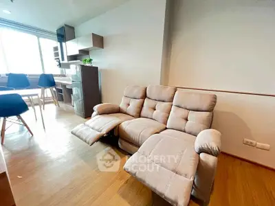 Modern living room with cozy recliner and stylish dining area