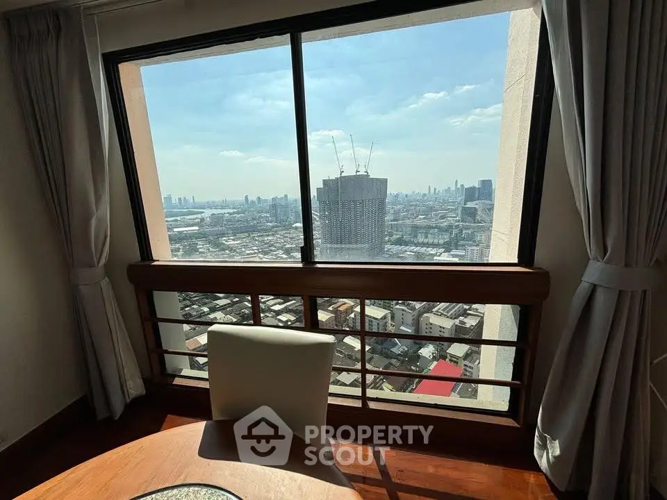 Stunning cityscape view from high-rise apartment window with elegant interior decor.