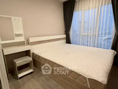 Modern bedroom with city view, featuring a cozy bed and stylish vanity in a high-rise apartment.