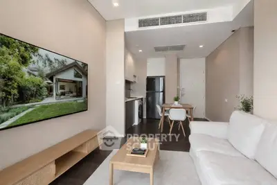 Modern living room with sleek furniture and open kitchen layout