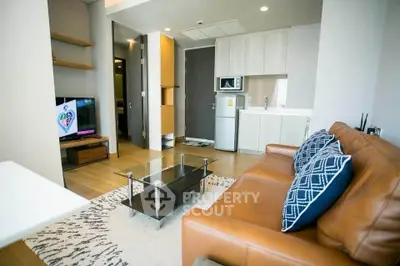 Modern living room with leather sofa and glass coffee table in stylish apartment.