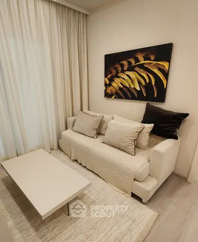 Cozy living room with elegant sofa, modern art, and soft lighting