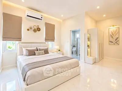 Luxurious bedroom with elegant decor and ensuite bathroom in modern apartment