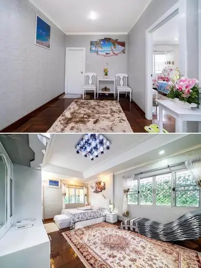 Spacious bedroom with elegant decor and natural light, featuring cozy seating area and stylish furnishings.